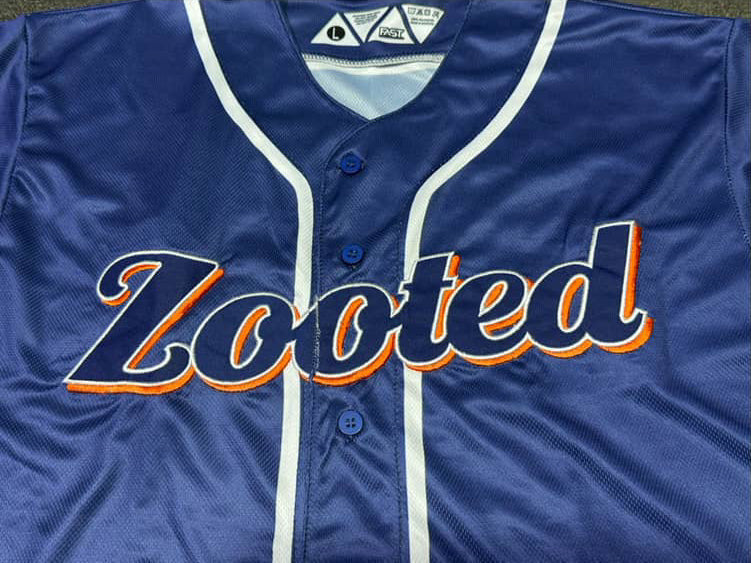 Blue sports jersey with 'Zooted' branding on a dark background